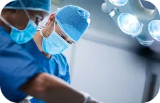 A surgical team performing a precise medical procedure under operating lights, a private polyclinic in Belgrade