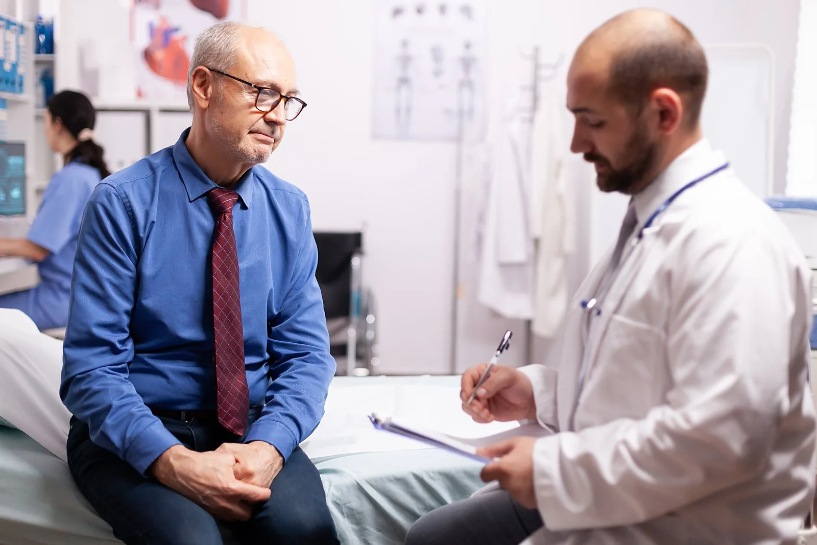 A neurologist talking with a patient during a consultation in the consulting room